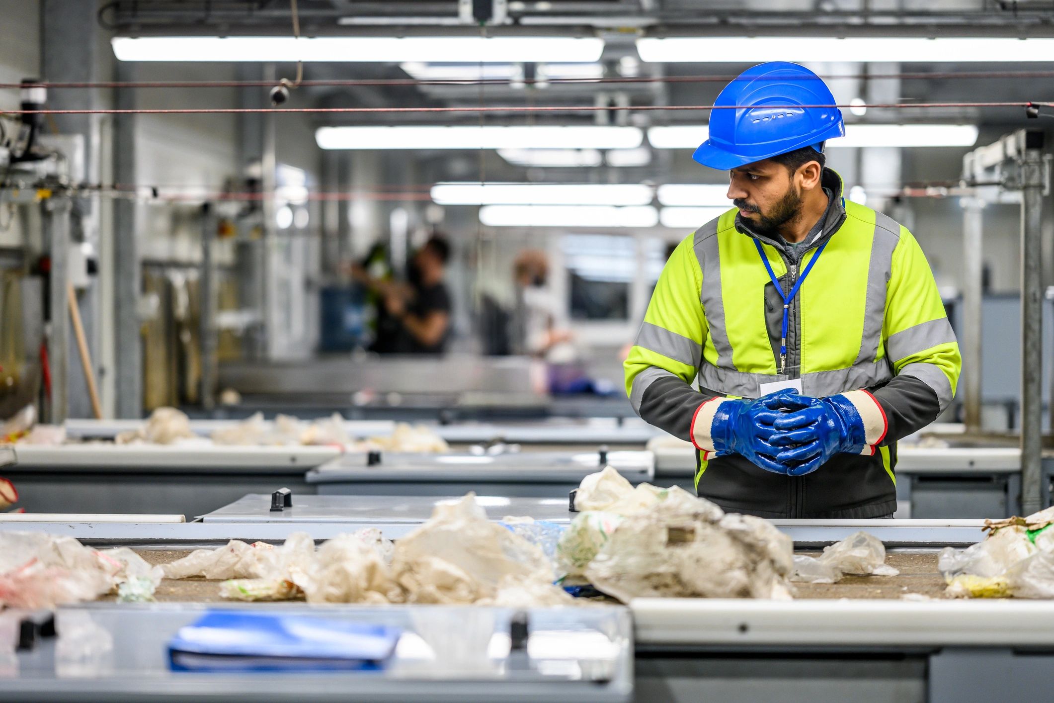 Worker inspecting packaged materials in an industrial production setting