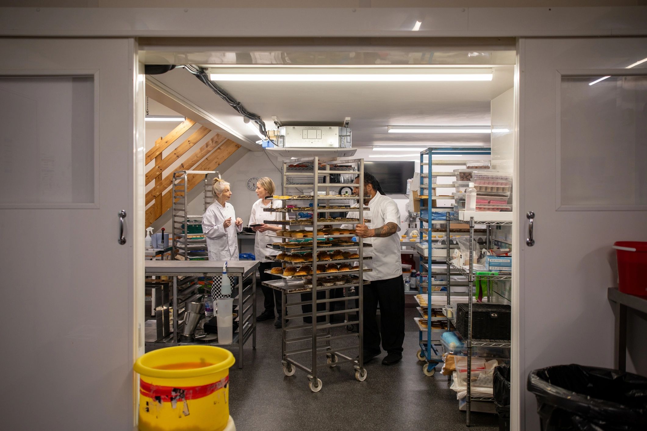 Commercial kitchen team coordinating a pilot production run