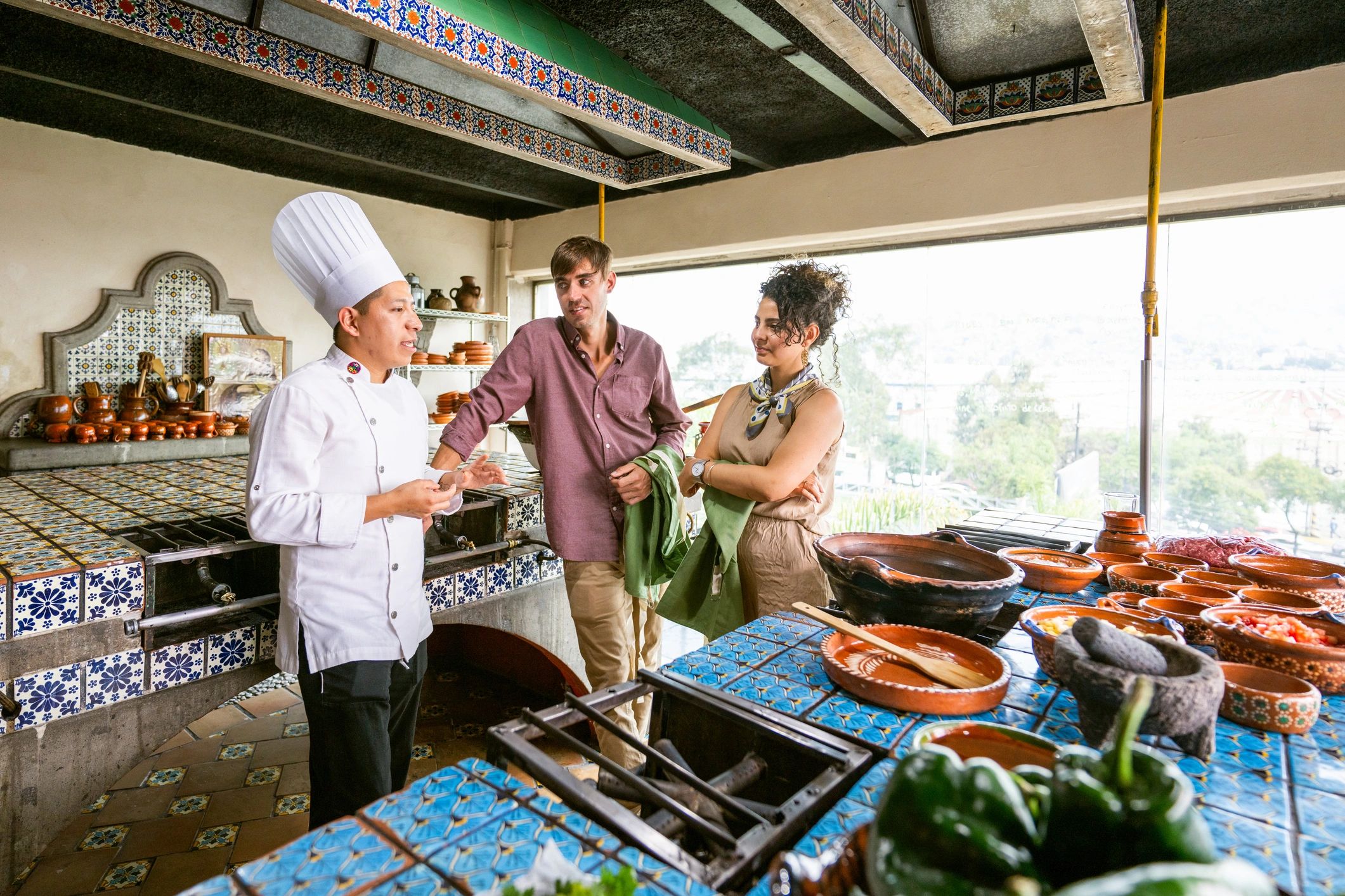 Commercial kitchen team preparing food in a professional production environment